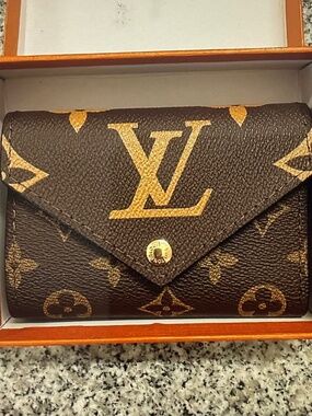 Louis Vuitton Monogram Portefeuille Victorine Tri-fold Wallet.